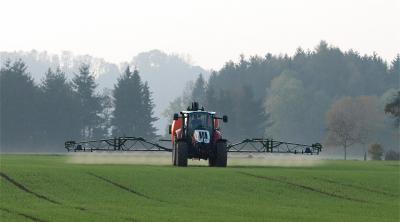 Tractor spraying crops